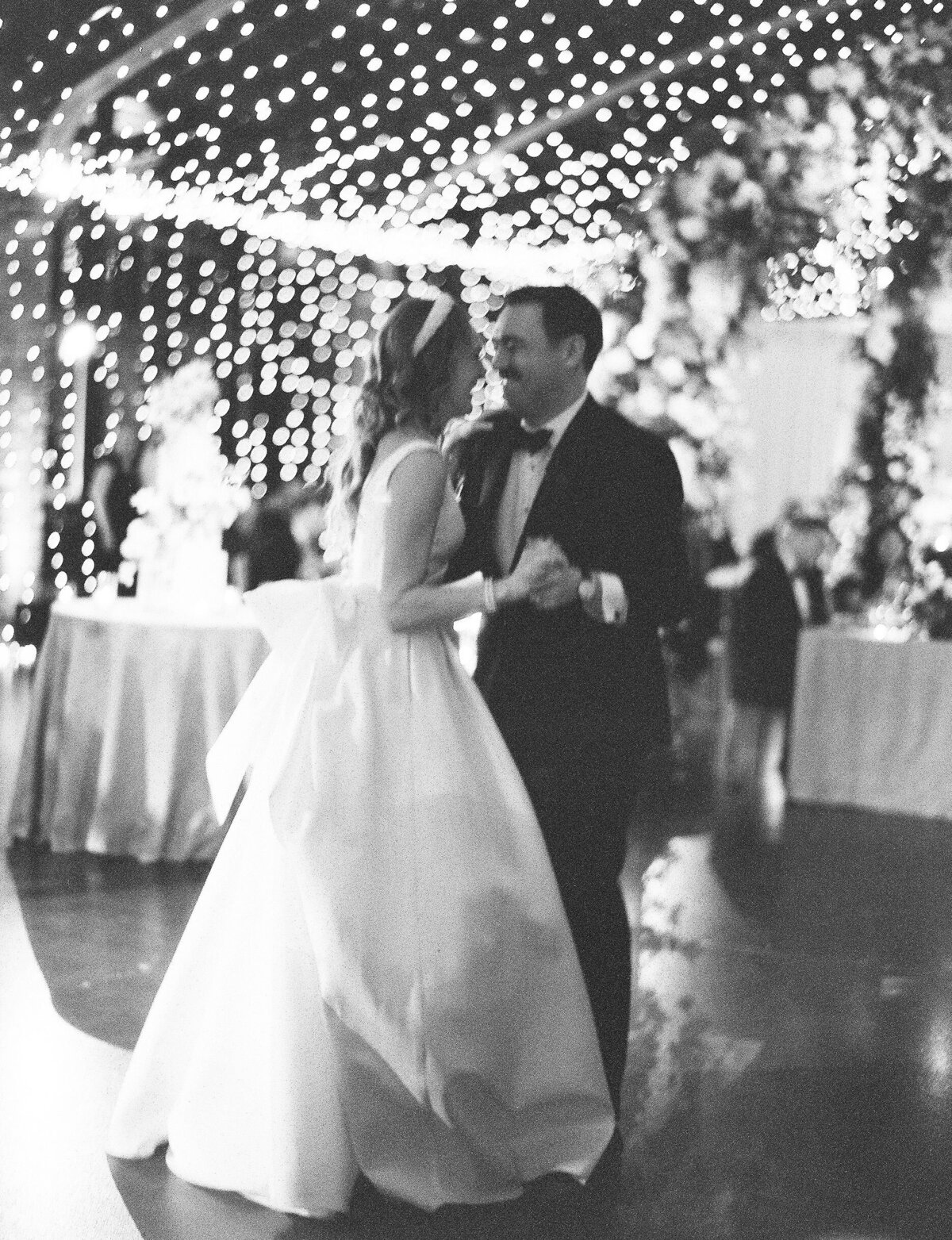 Black and white photo of the bride and groom dancing at the Theater on the Lake. 