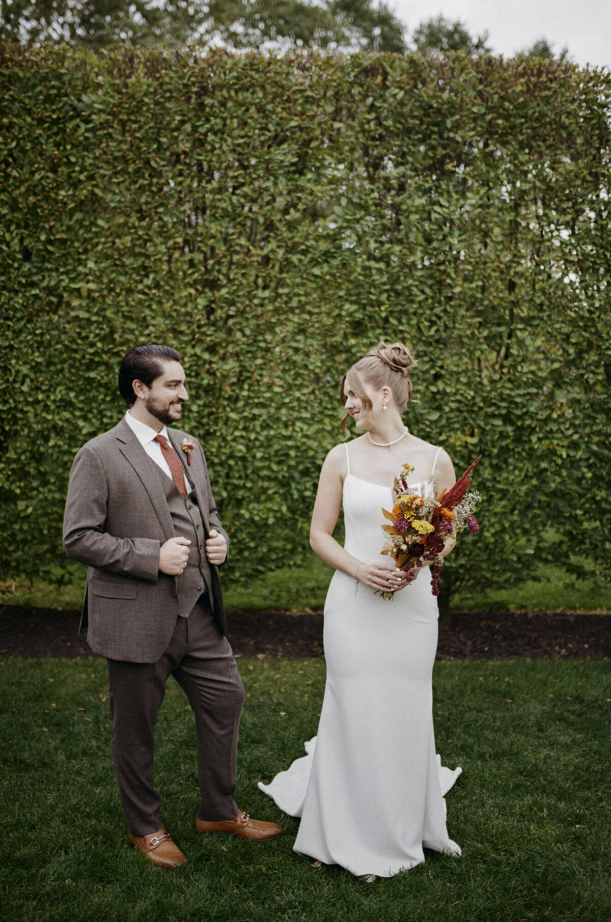 35mm film wedding photo of a couple in front of the greenery at The Roundhouse in Beacon, NY