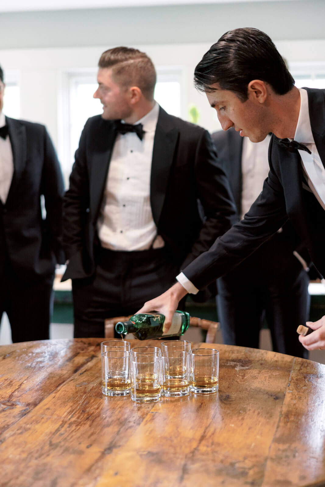 The groom and groomsmen are about to drink brandy at Lion Rock Farms, CT. Image by Jenny Fu Studio