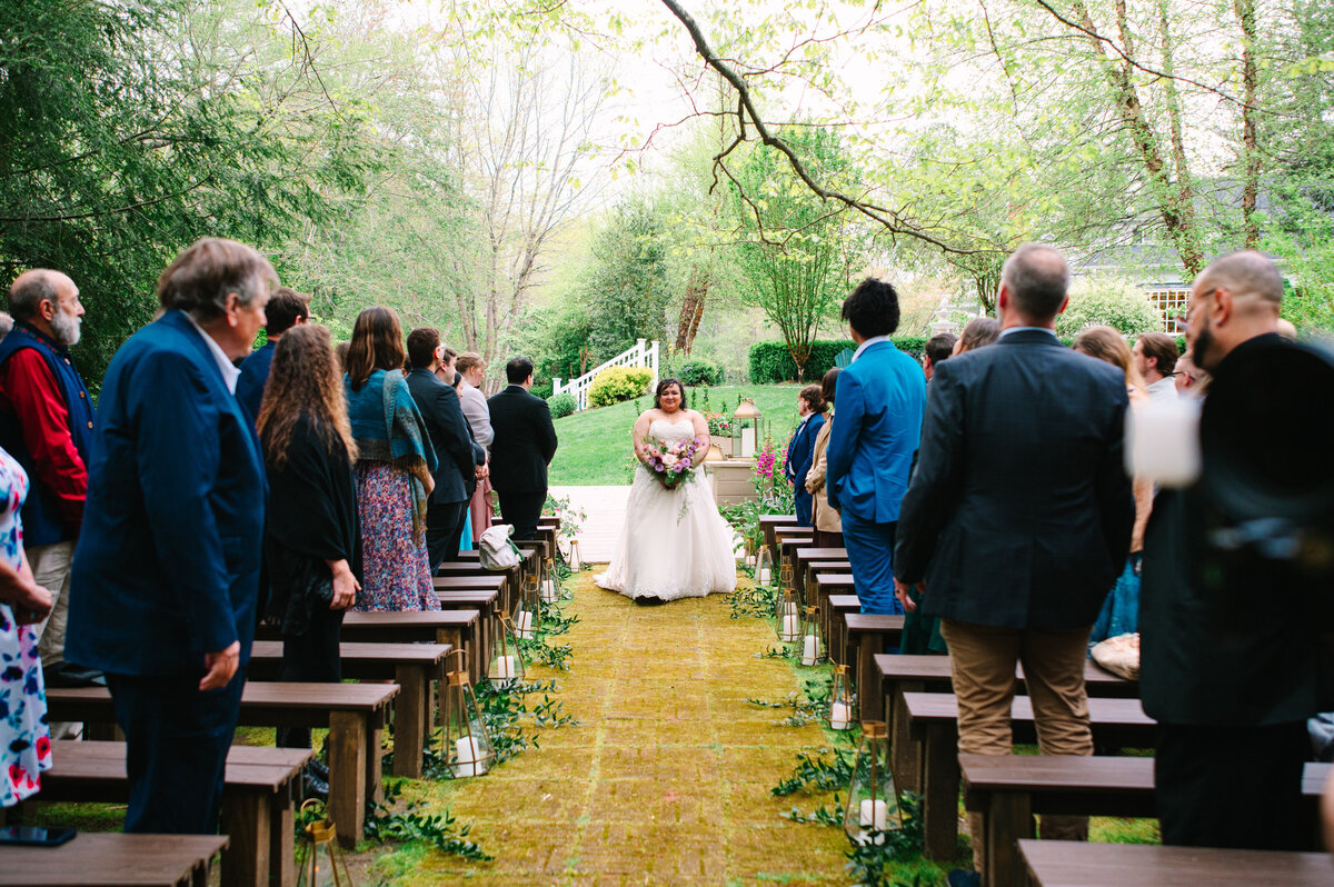 Bride in wedding dress walking down the aisle