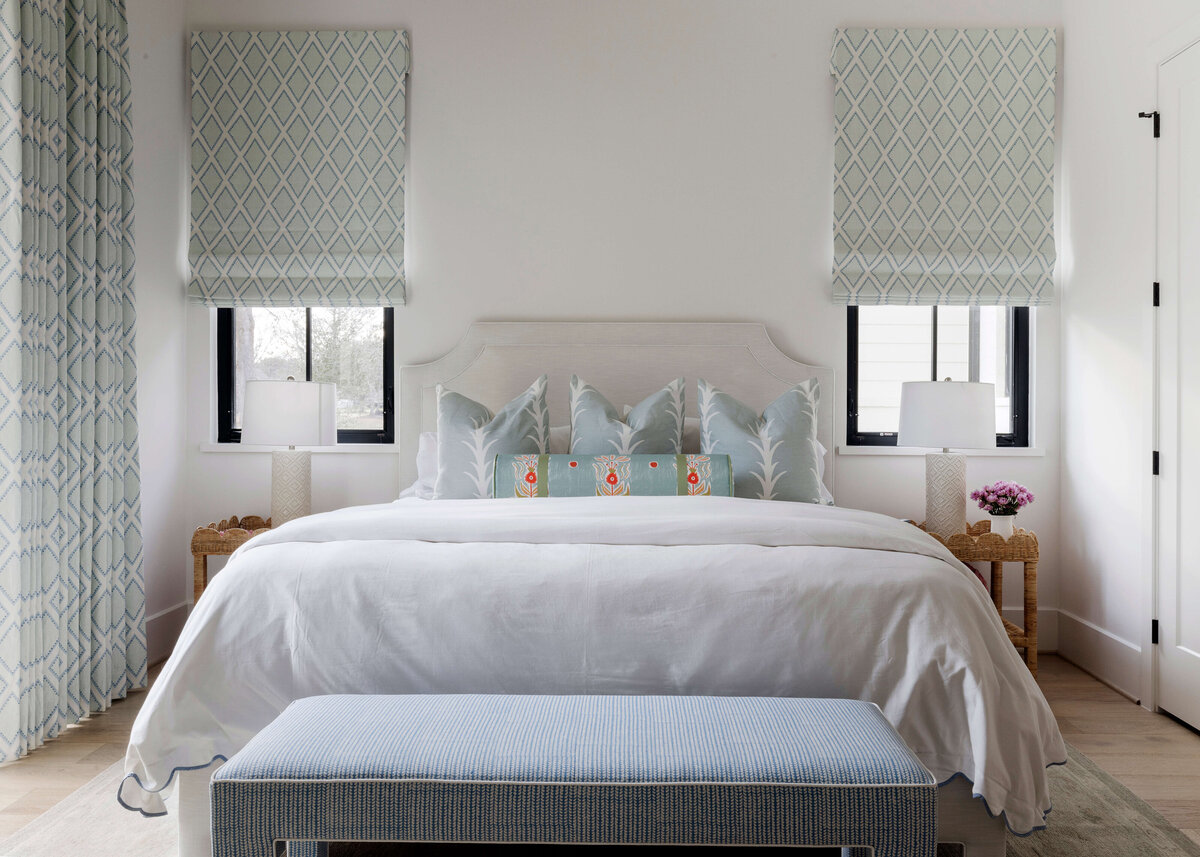 oyster creek studios missouri city new build white bed and light blue pillows in bedroom
