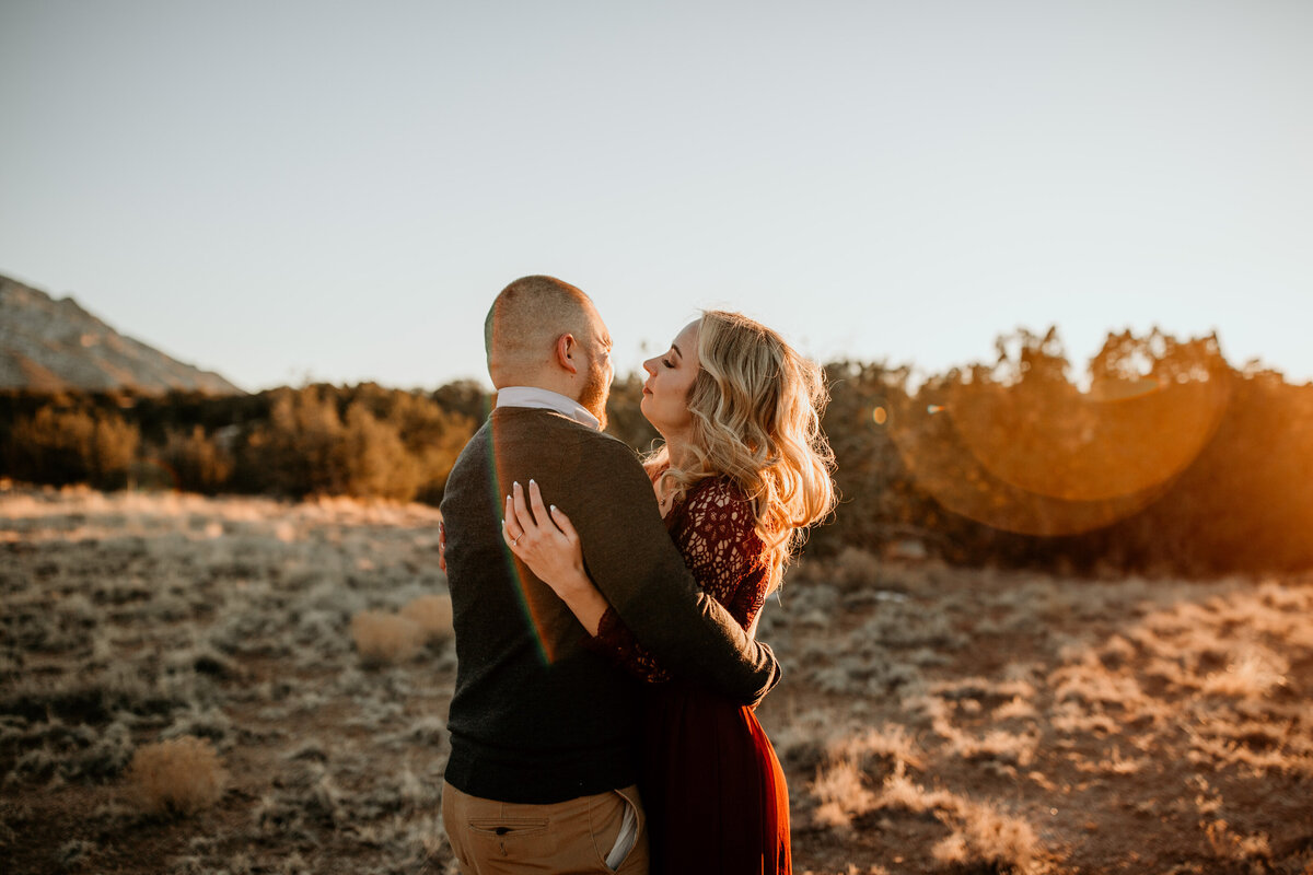 engaged couple dancing in the desert