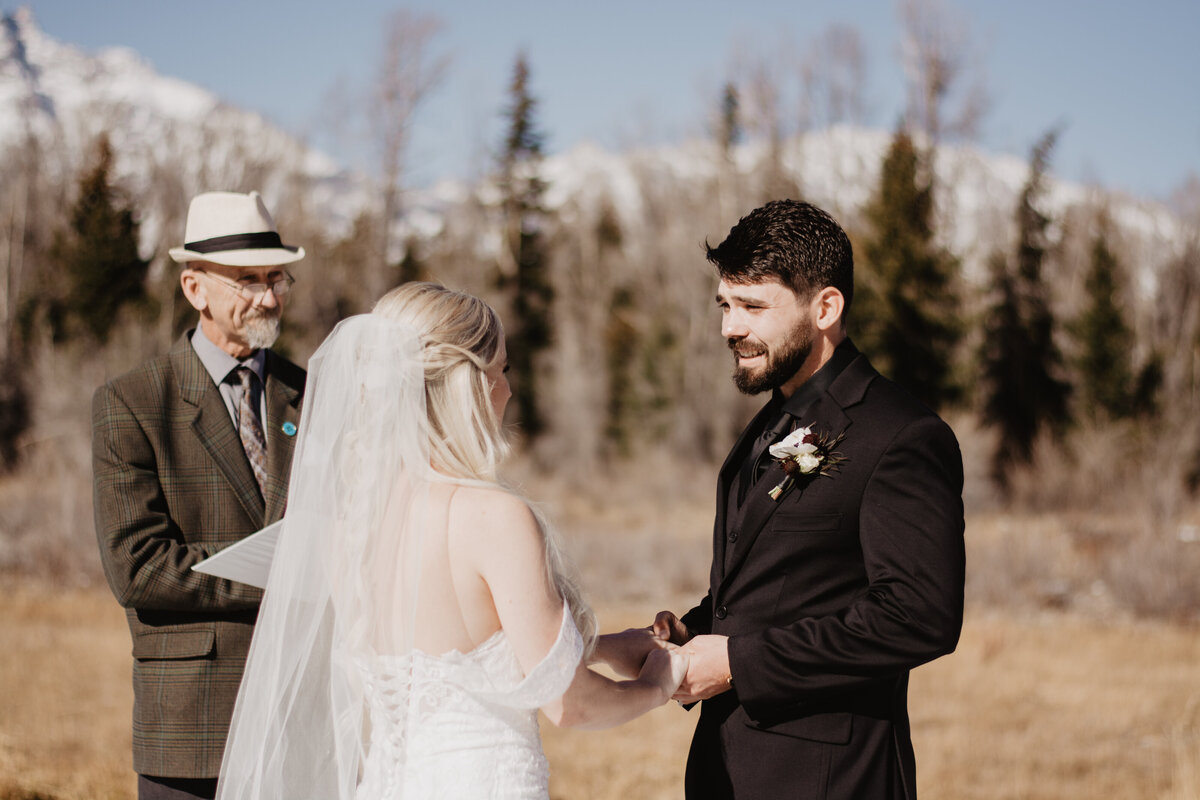 Jackson Hole Photographers capture groom holding bride's hands