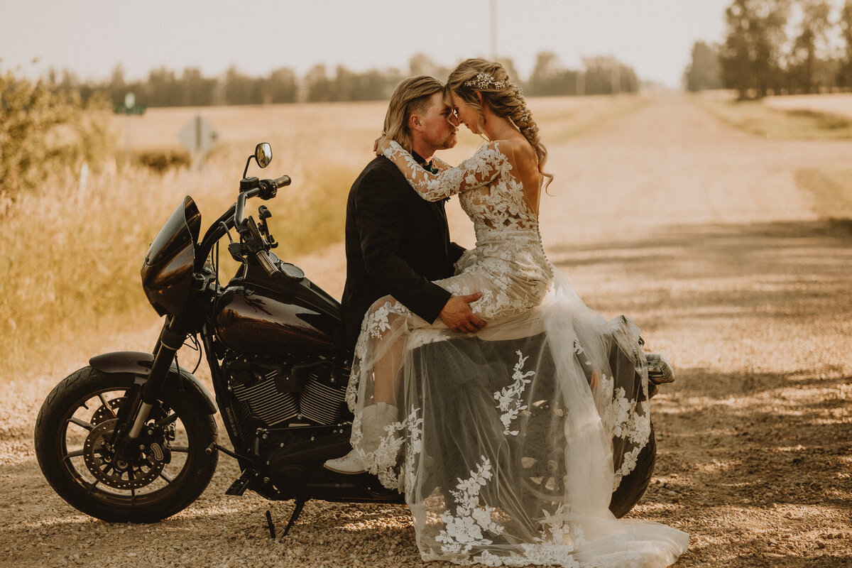 Couple sitting on a harley snuggling up in Edmonton, AB