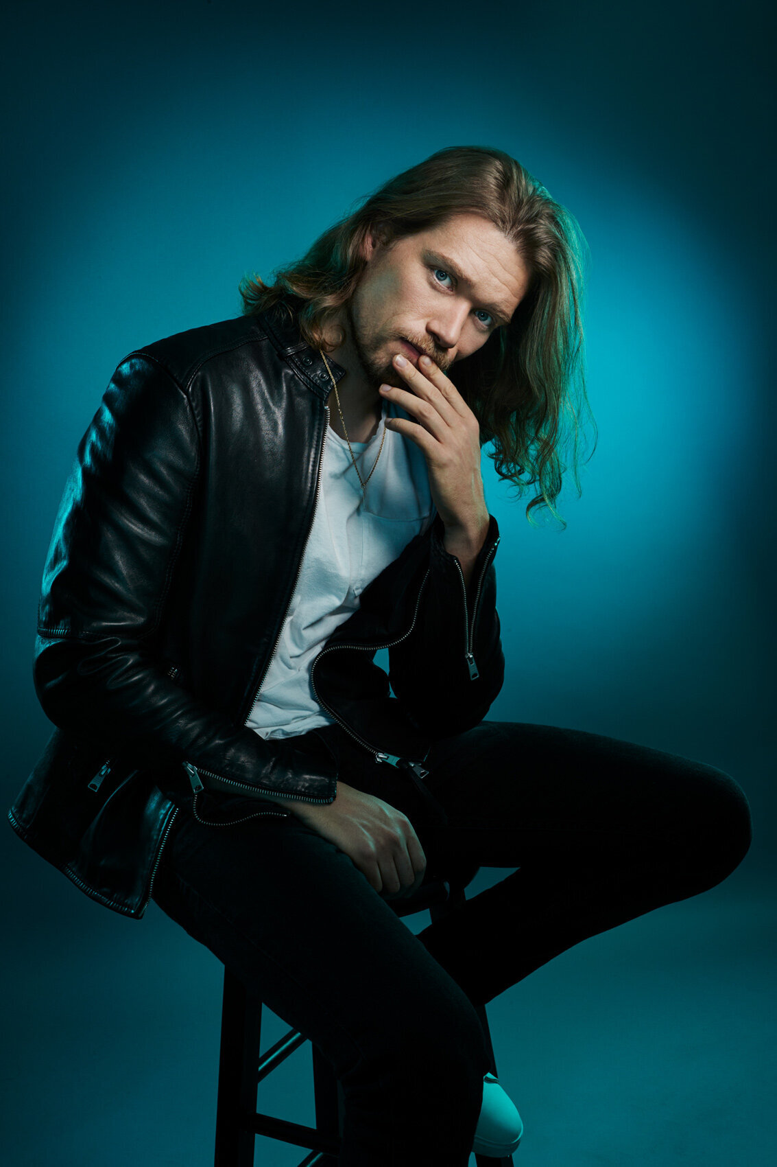 Bold portrait of Cameron Cowperthwaite in a leather jacket, showcasing a confident pose by Ylva Erevall.