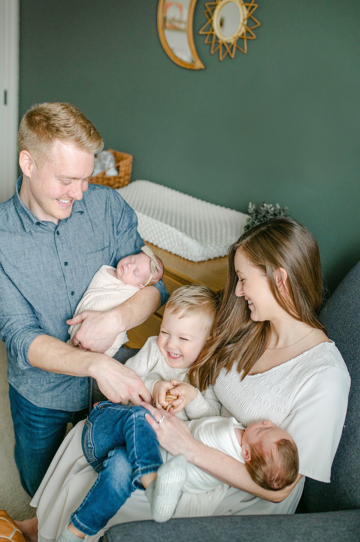 Family tickling eachother at Milwaukee newborn session