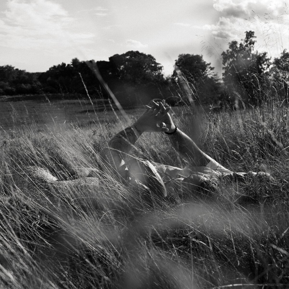 Documentary-style photo of a groom and bride walking through open landscape, symbolizing new beginnings