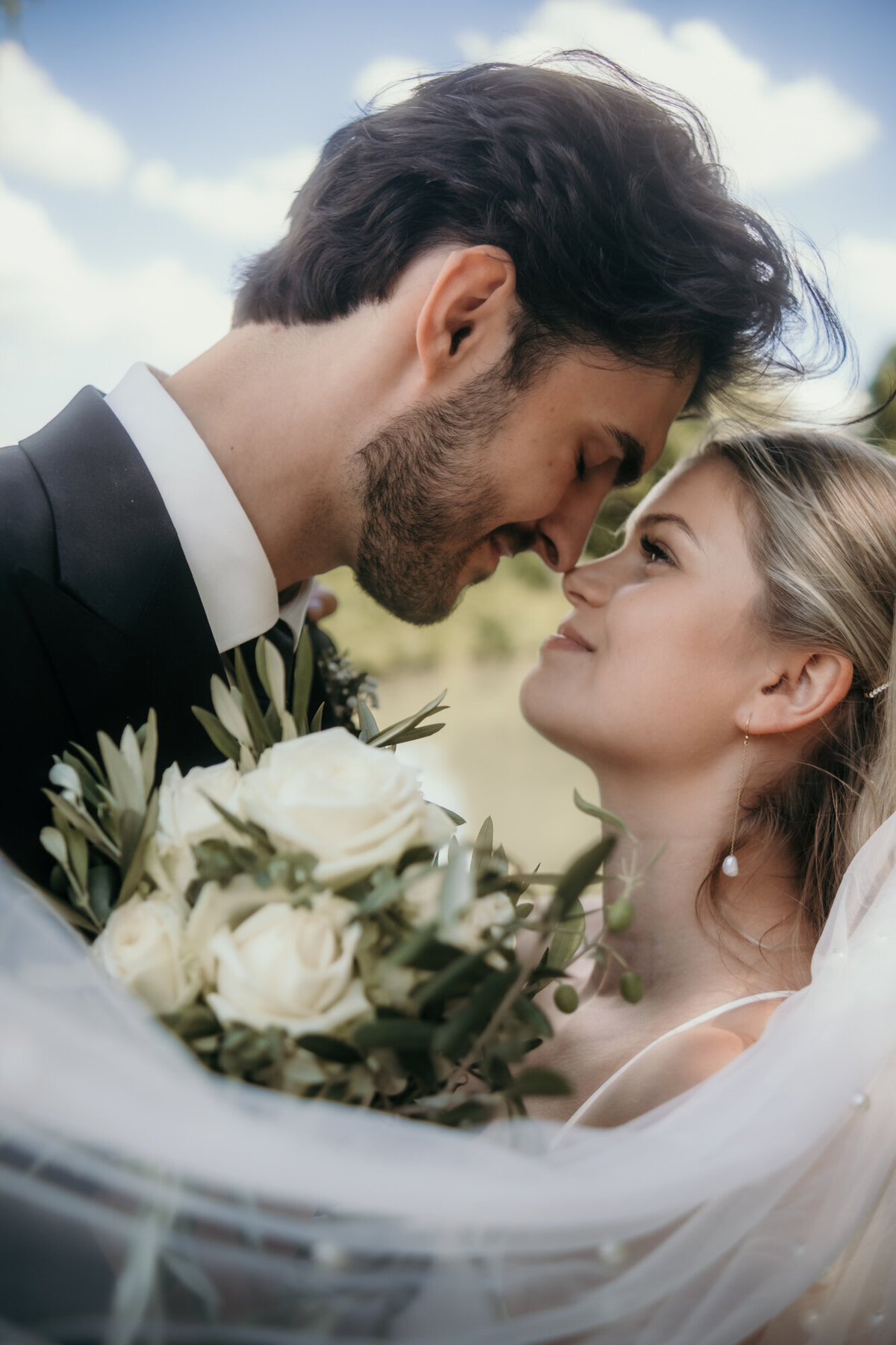Bride and groom look each other deep in the eyes.