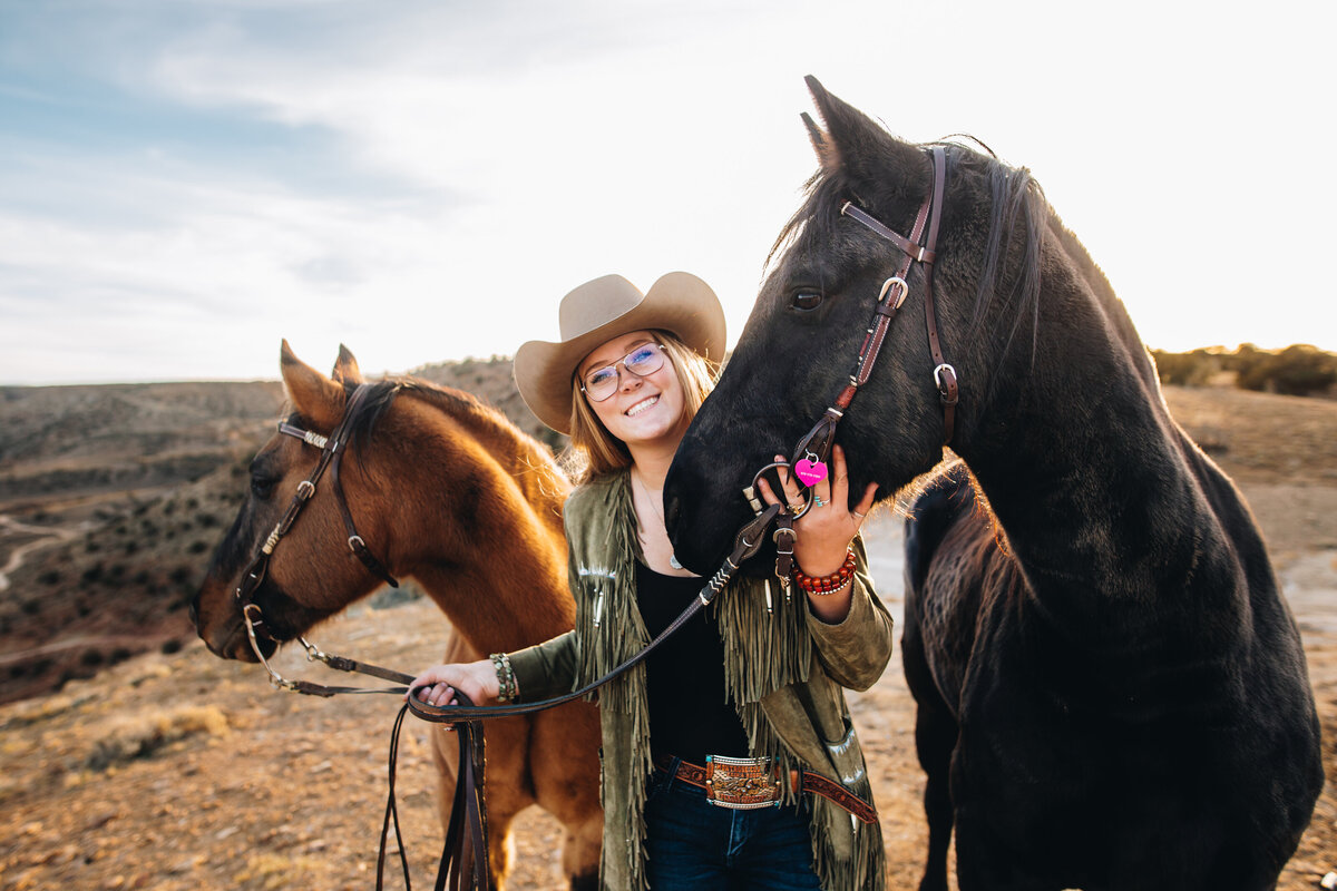 Heather poses with her horses for her Montrose senior pictures.