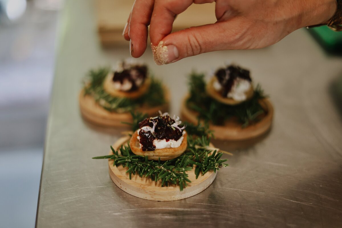 Charlotte Roy the chef adding finishes touches to a plant based dish