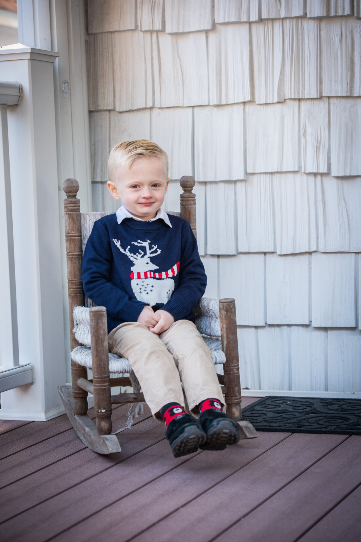 A small child sitting in a rocking chair