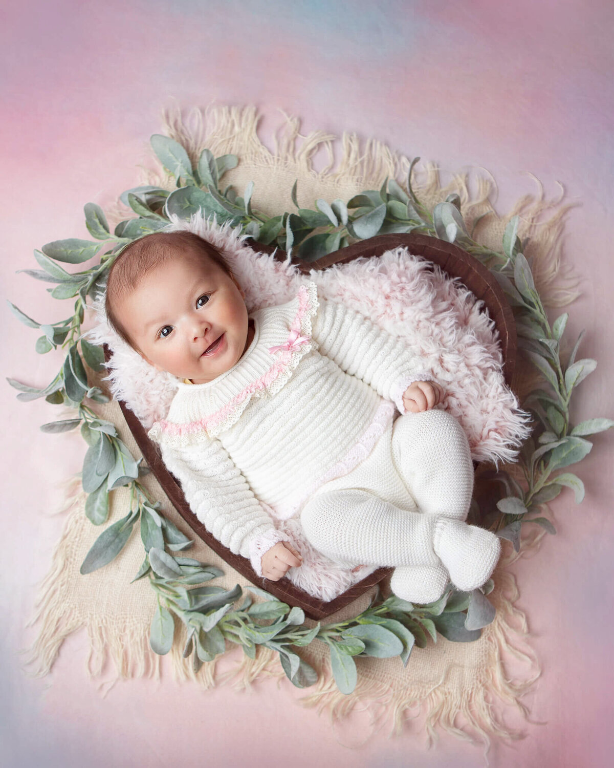 3 month old baby girl laying in a heart bowl on a pink backdrop photographed in Calabasas - By Los Angeles Newborn Photographer