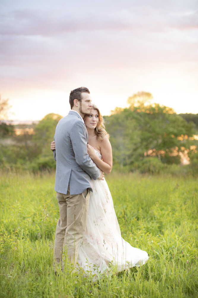 couple posing in tall grasses