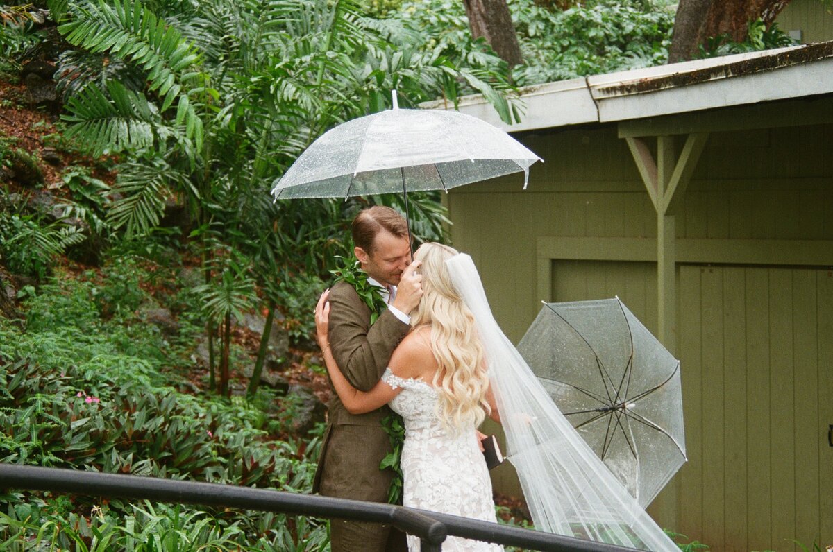 Luxury wedding couple at five-star Hawaiian resort, bride in strapless satin gown and long veil