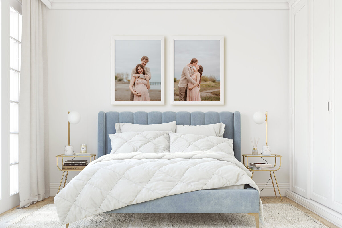 Two framed fine art prints hang above a white and blue bed
