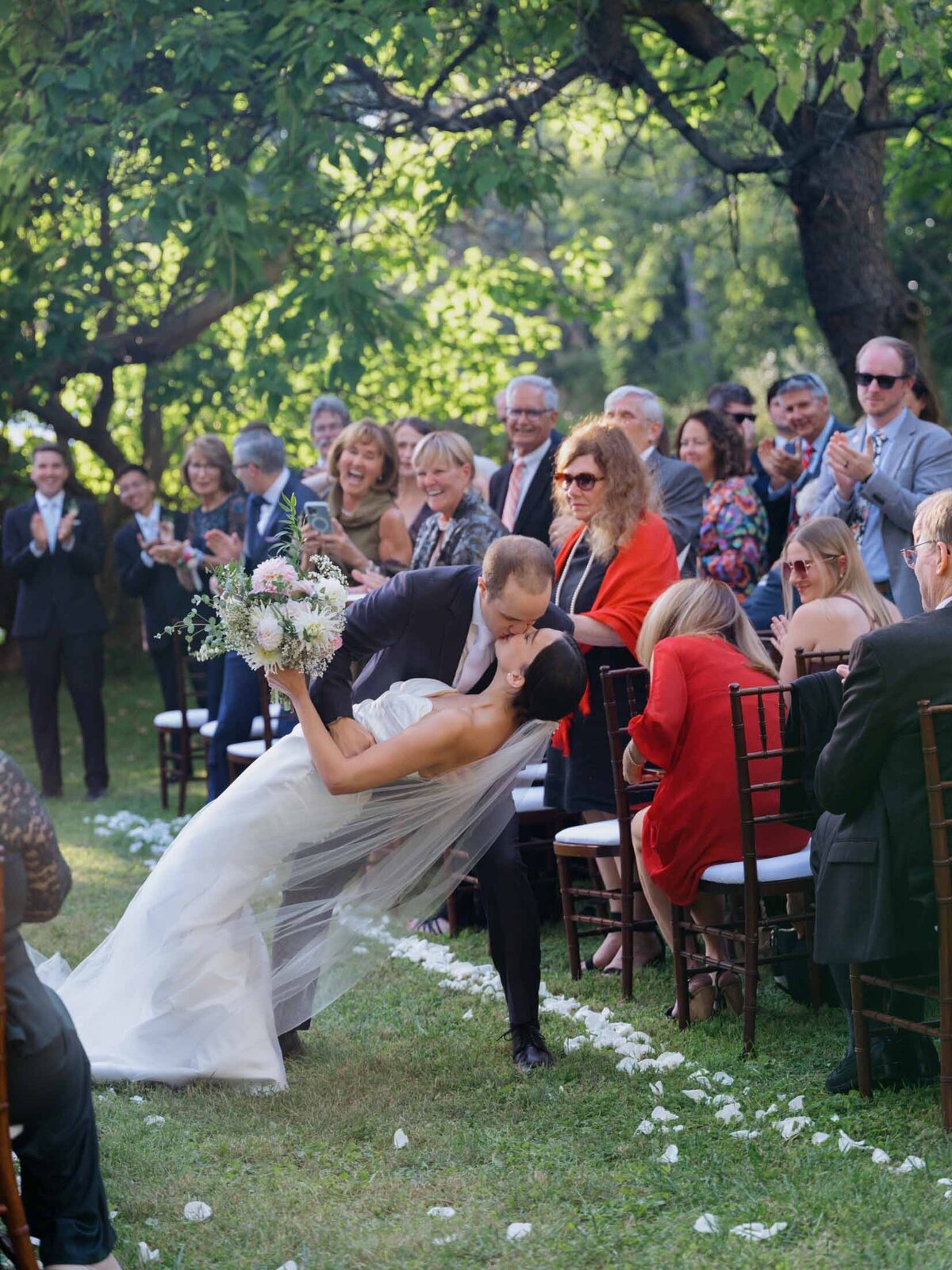Outdoor wedding ceremony under clear blue sky.