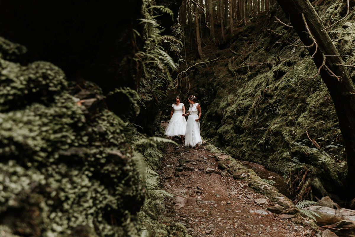 two brides walking in the woods
