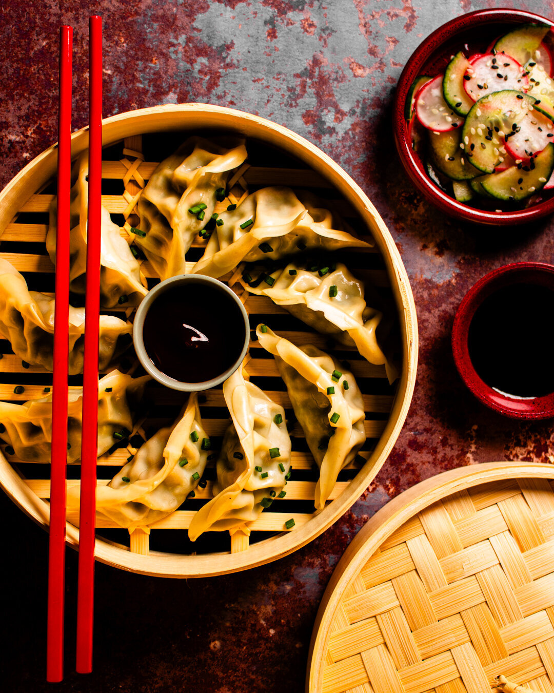 gyoza in a bamboo steamer with salad