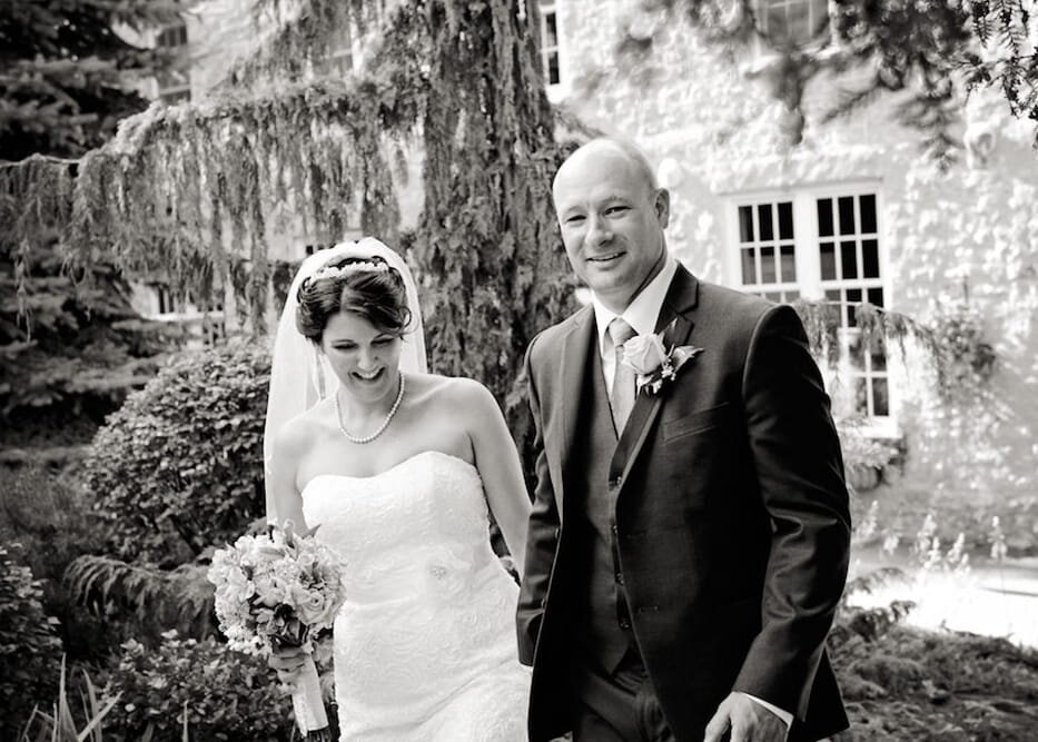bride-groom-smiling-holding-hands-garden-wedding
