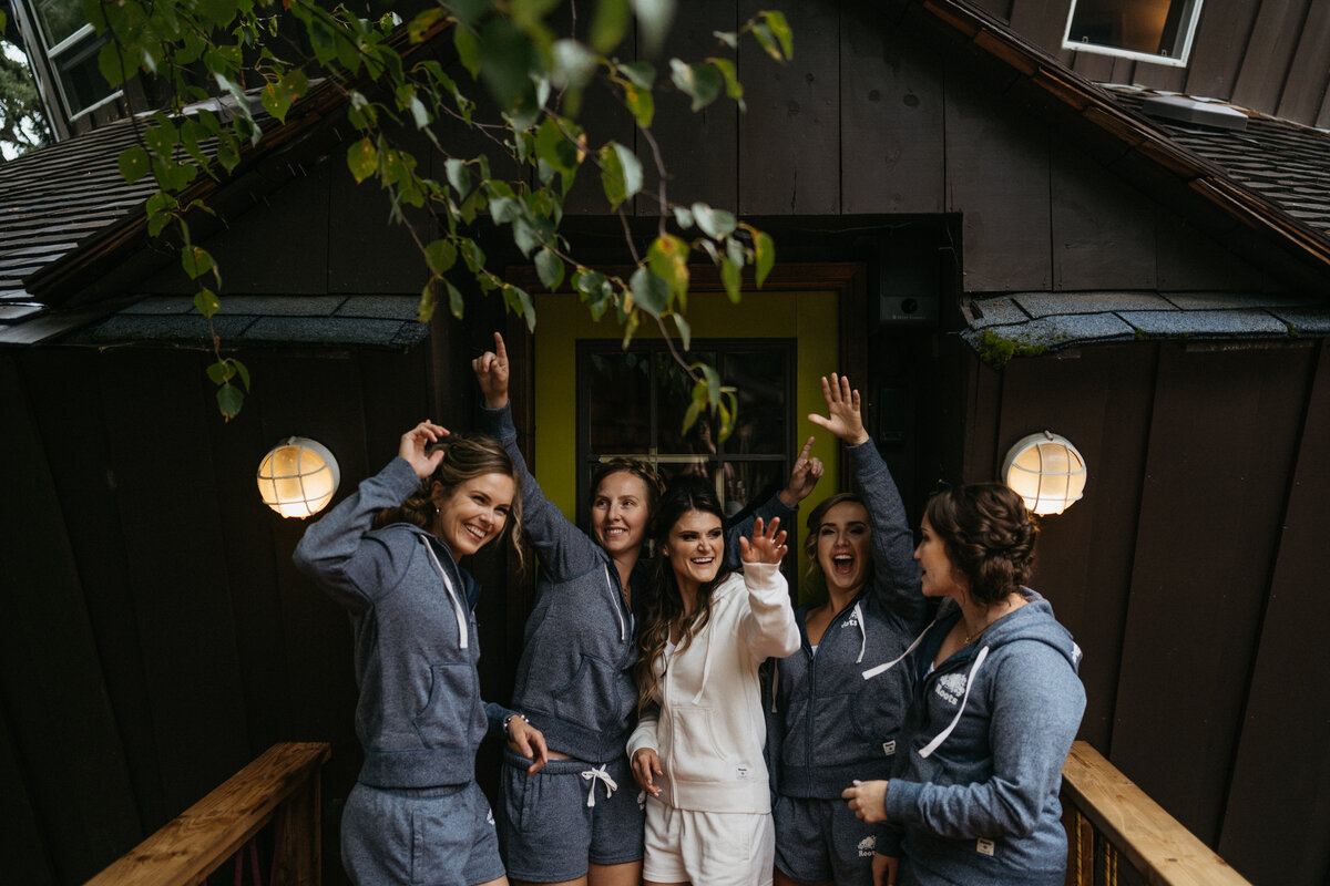 bridal party in front of cabin