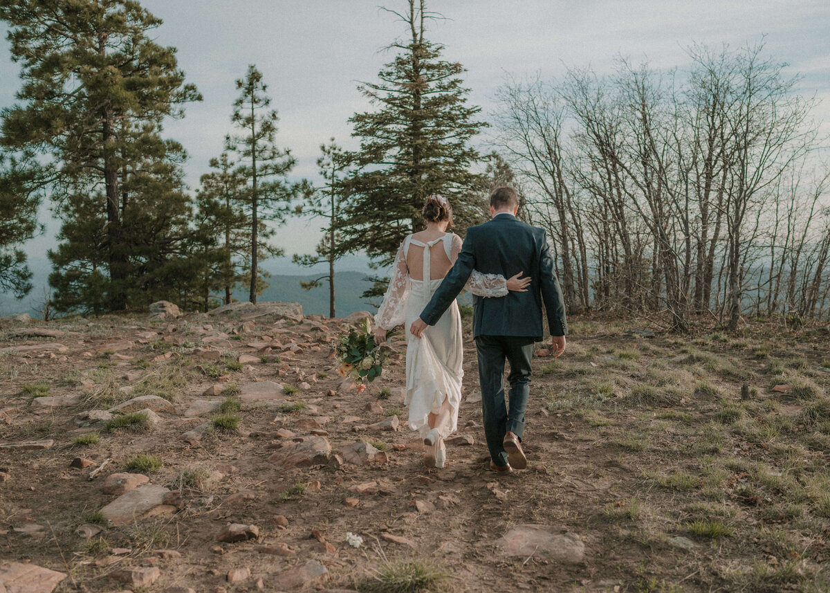 bride and groom walking through mogollon rim forrest in payson, arizona