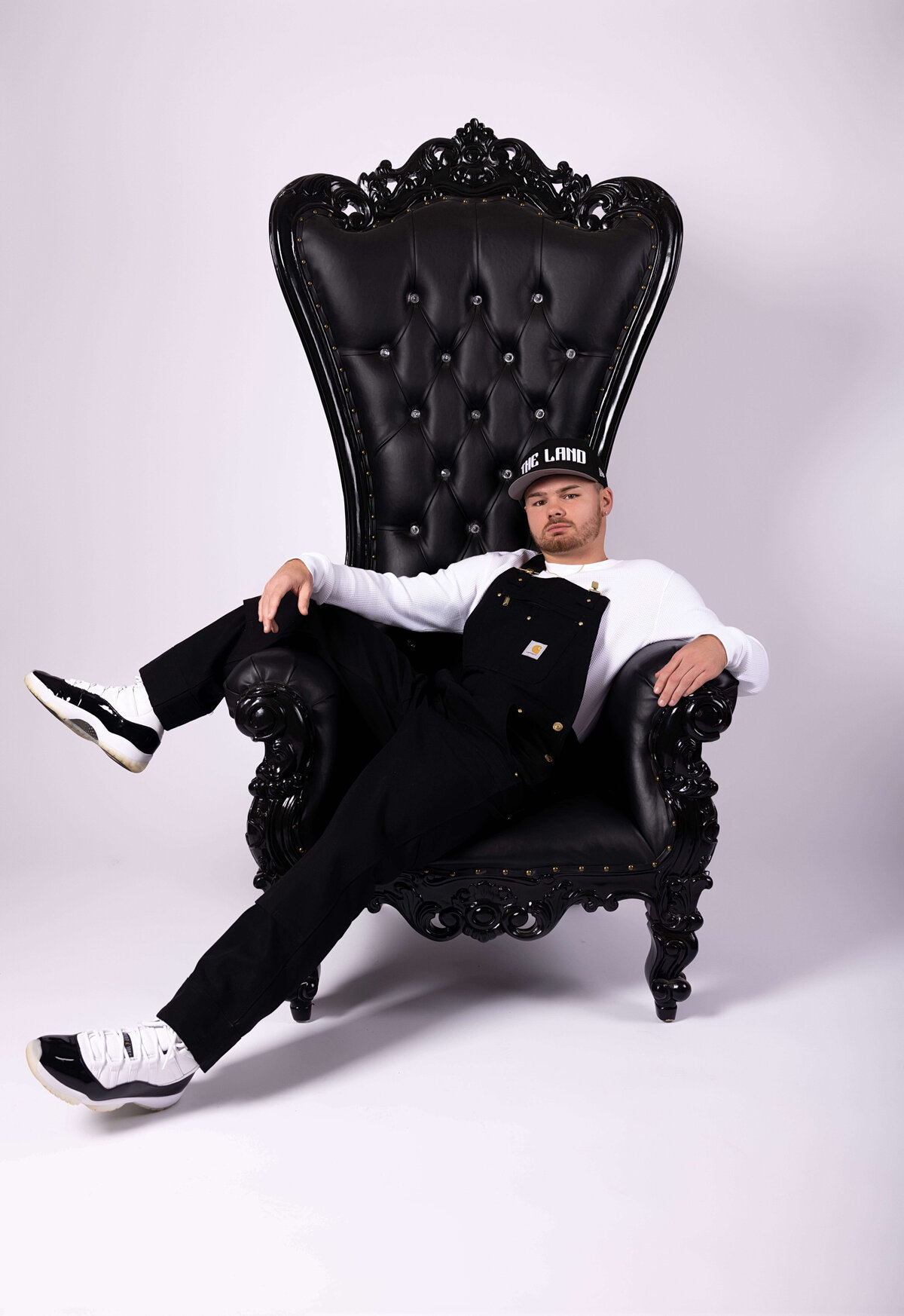 Professional boxer sitting in throne chair in birthday session with Reva Davis photography