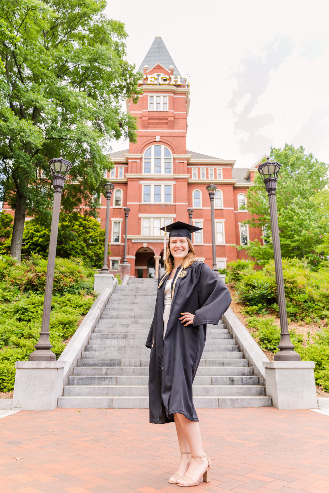 college graduation girl with cap and gown standing in font of Geargia Tech tower in midtown  | Atlanta GA family Photographer | Laure Photography