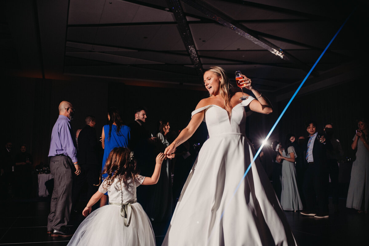 Bride dances with flower girl at reception in Ohio