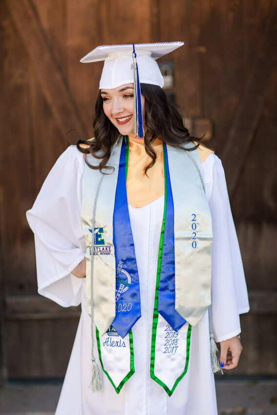 girl in white cap and gown standing