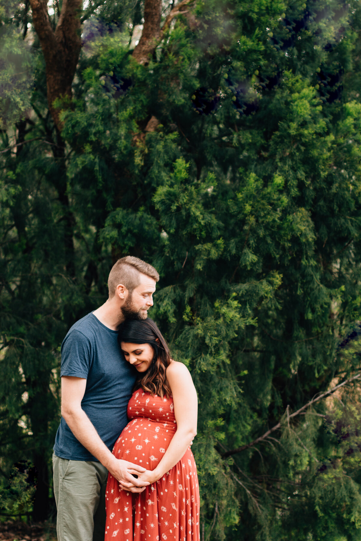 man hugging pregnant wife outside,  maternity photography Melbourne by And So I Don't Forget Photography