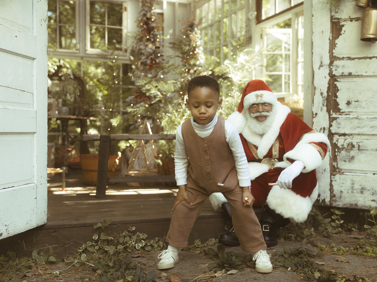 A boy acts silly with Santa at Das Hinterhaus.