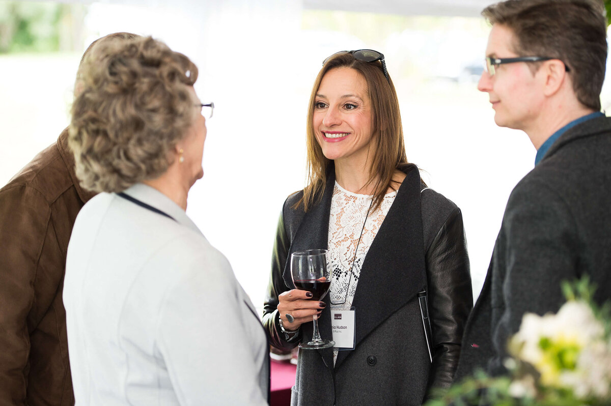 a candid photo of guests mingling at a corporate anniversary celebration.  Captured by Ottawa Event Photographer JEMMAN Photography COMMERCIAL