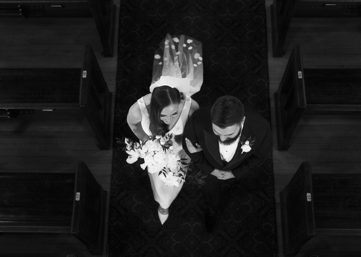 Bride and groom walking down the aisle of the church from above
