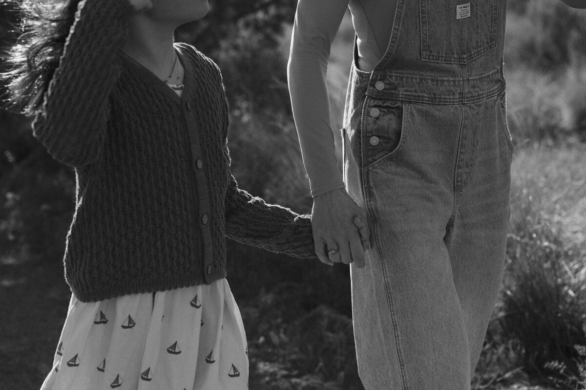 mother and daughter holding hands and walking along the trails at Smith Rock State Park in Bend, Oregon