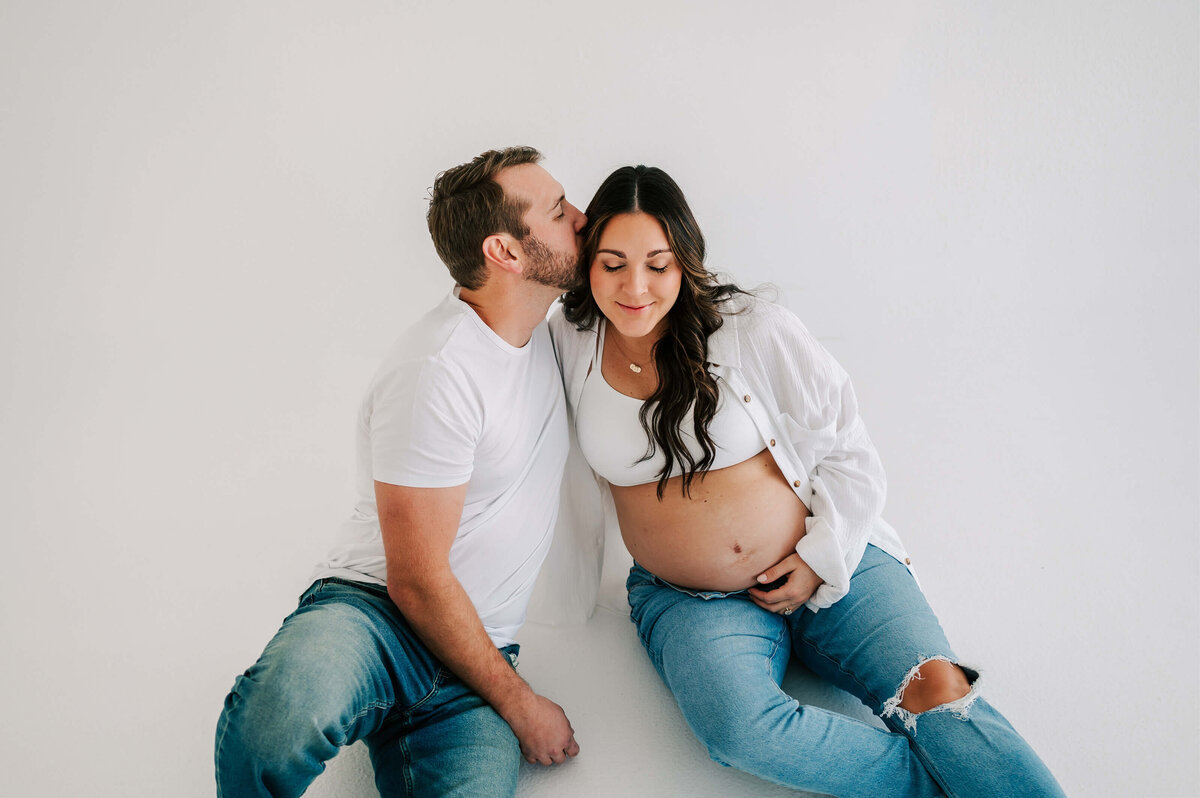 maternity picture in Branson MO of pregnant couple sitting on floor