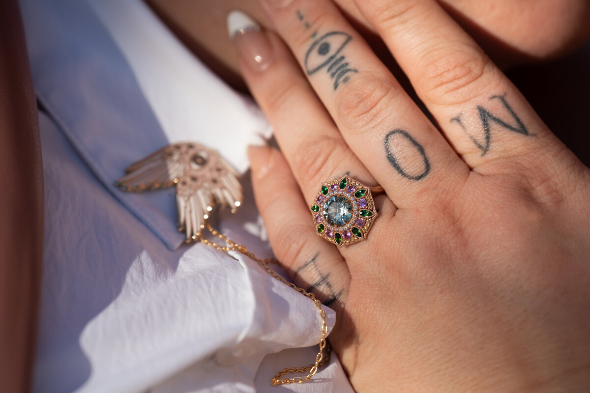 A close up of an engagement ring on a finger