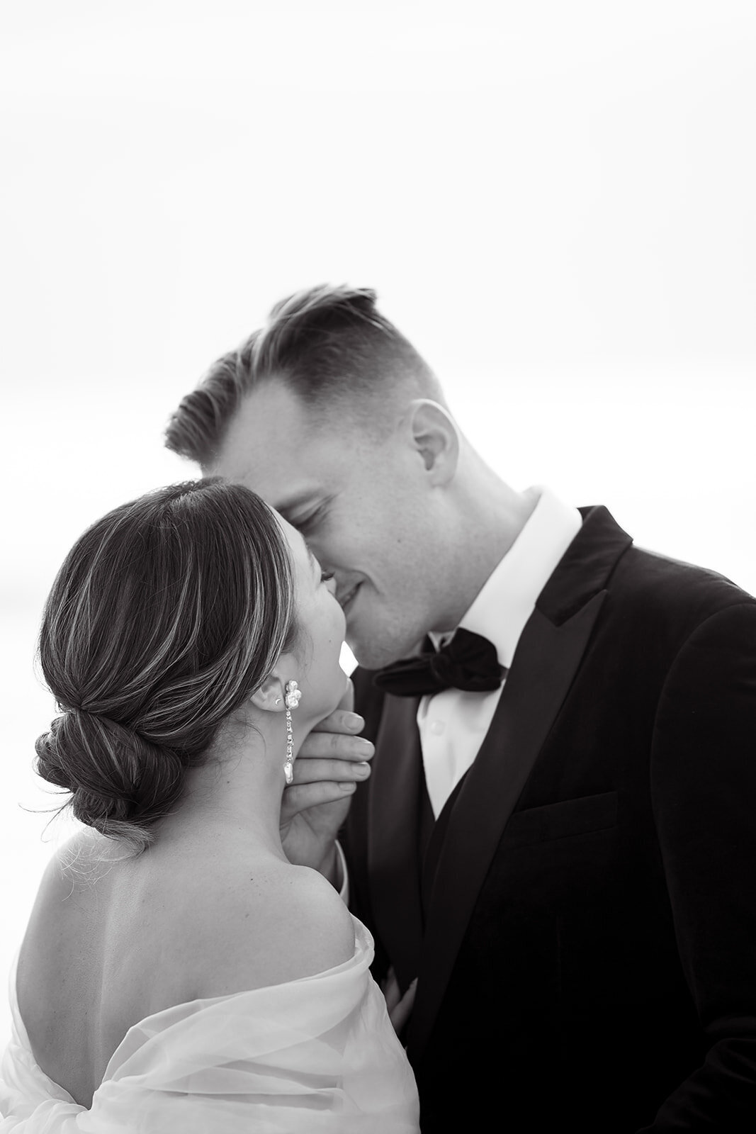 bride and groom kissing photo is black and white 