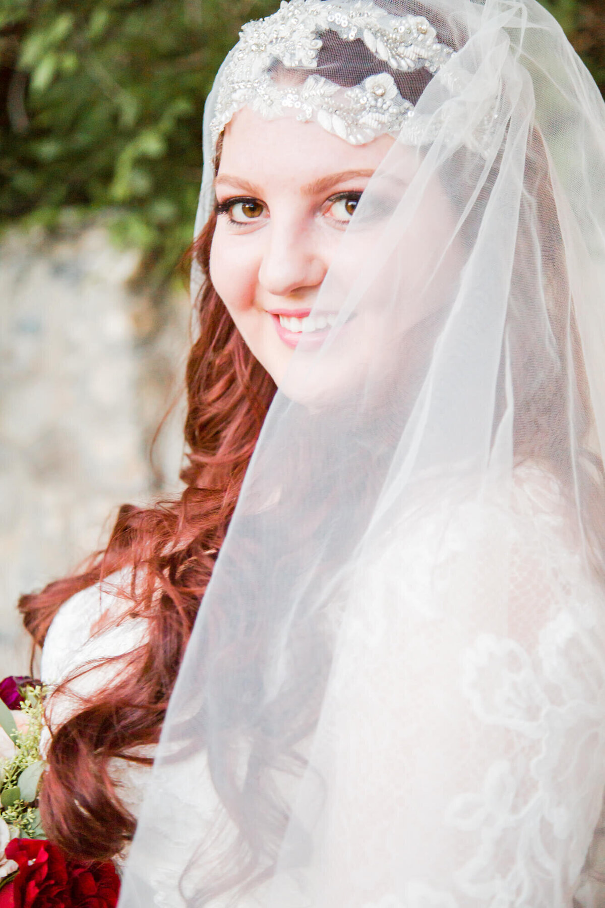 redheaded bride looking past her veil