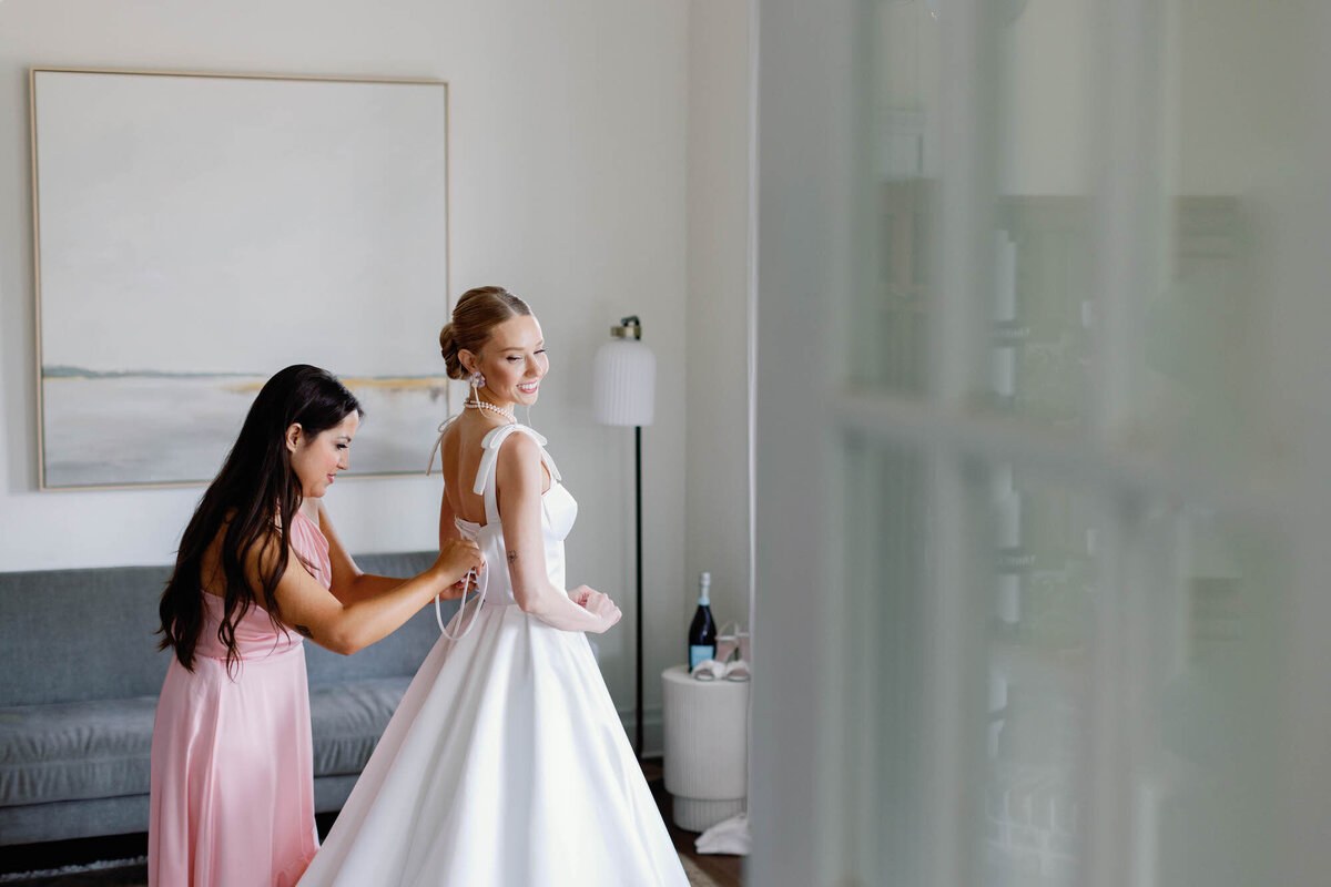 bride-putting-dress-on-at-the-grand-lady-austin-texas