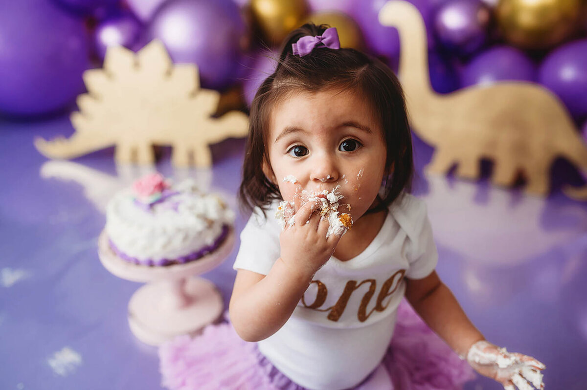 Baby enjoys birthday cake during Cake Smash Photos in Asheville, NC.