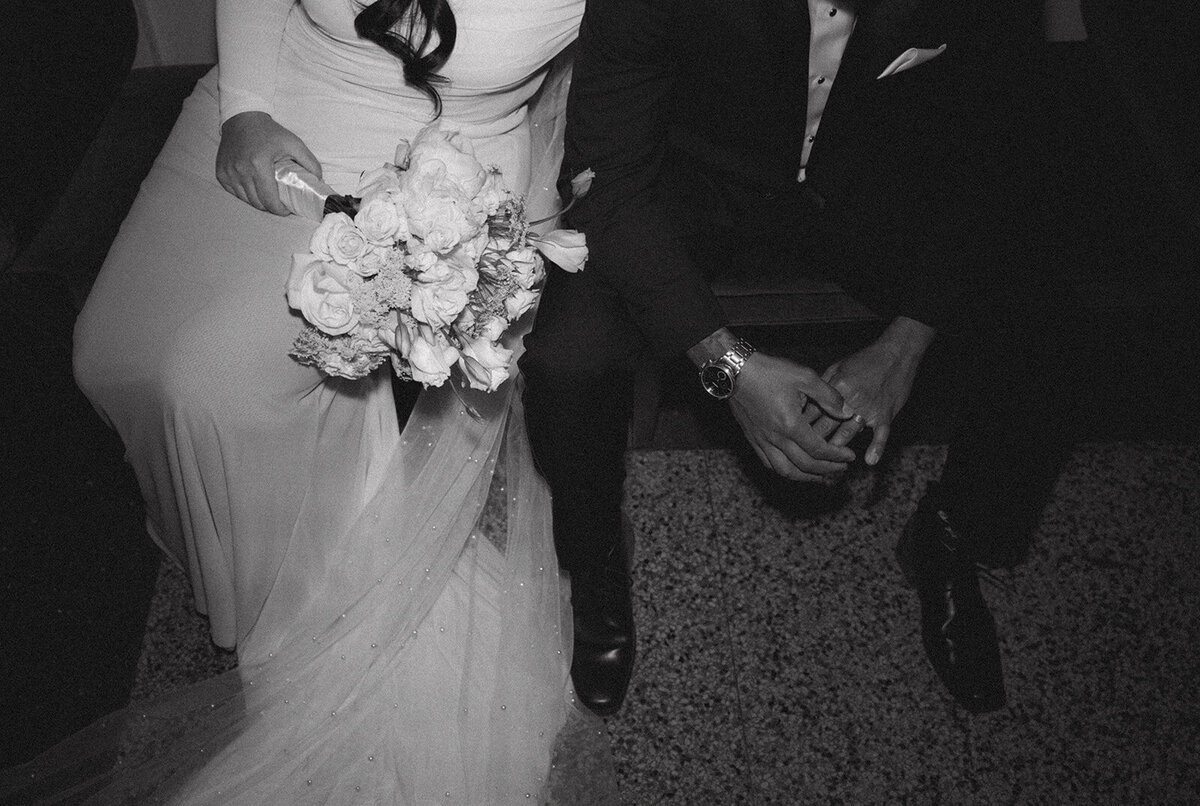 Bride and Groom seated with bridal bouquet