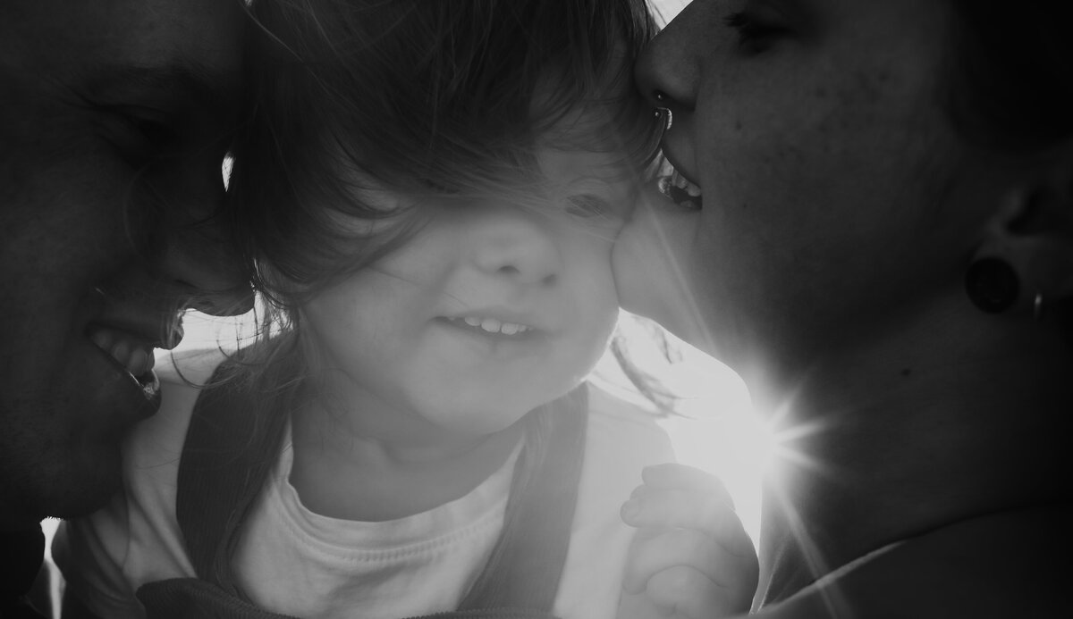 black and white picture of family of 3 , sun rays coming though, White Sands New Mexico