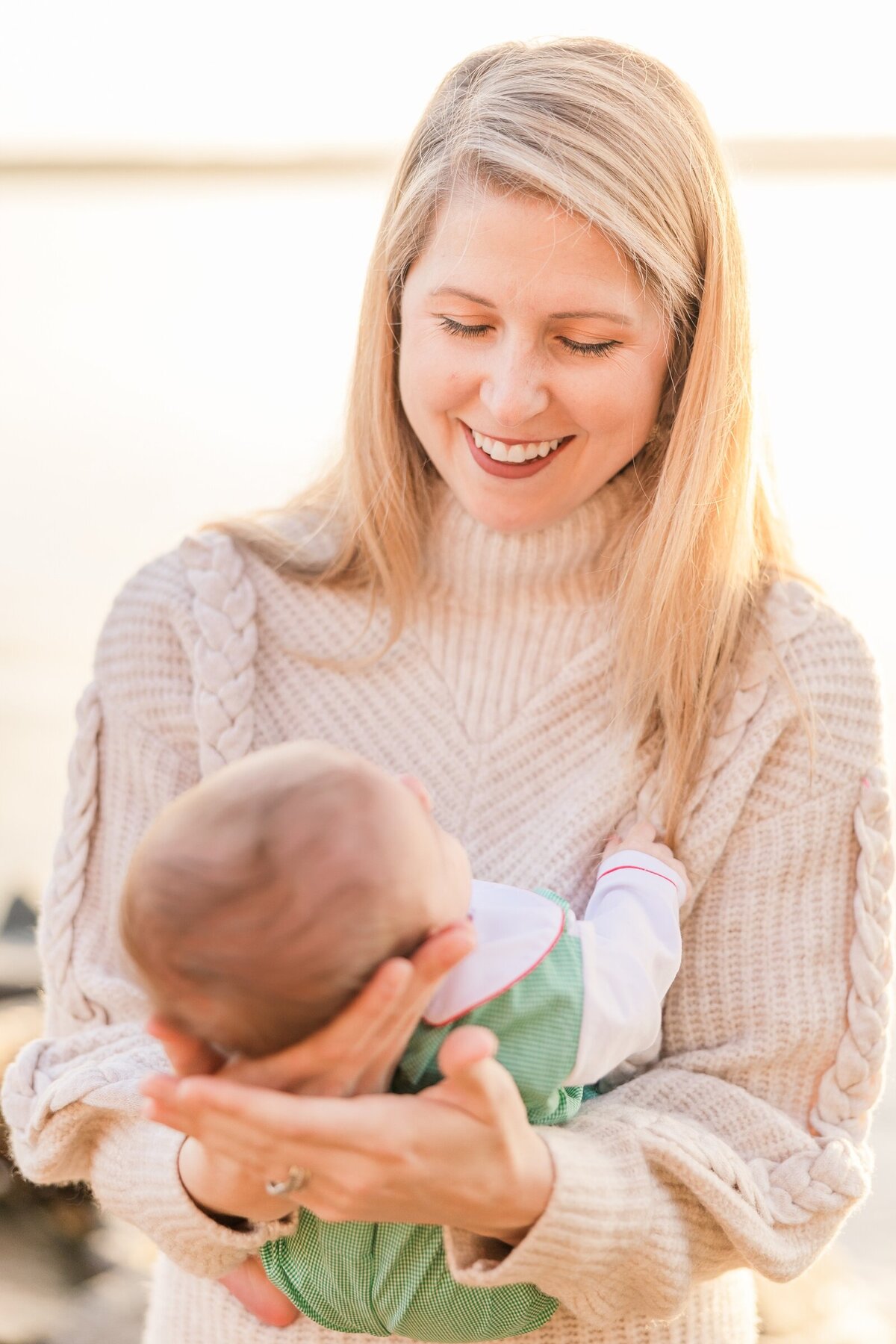 New mom smiling at her baby in Founders Park in Alexandria, VA