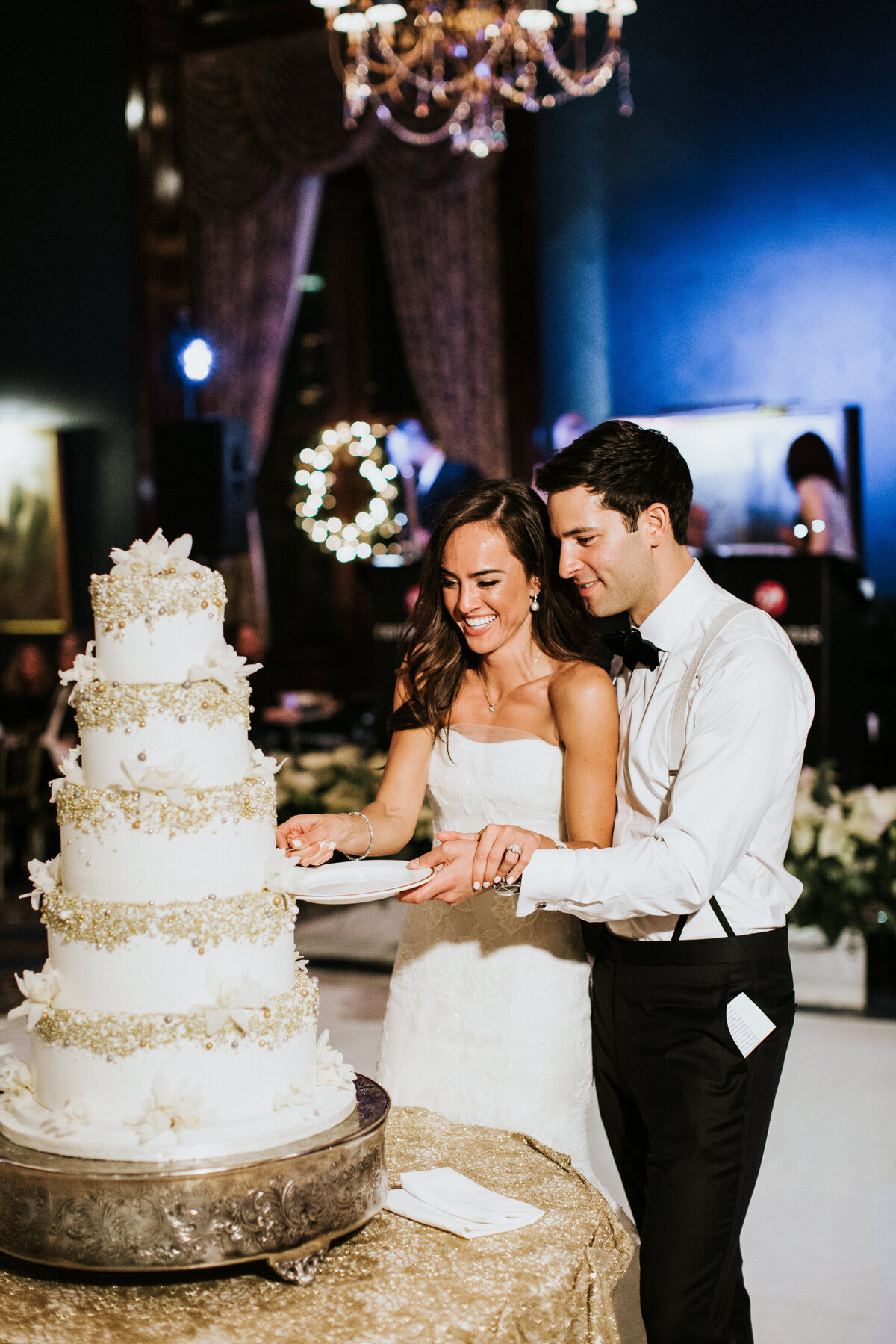 Bride and groom cutting five tier wedding cake