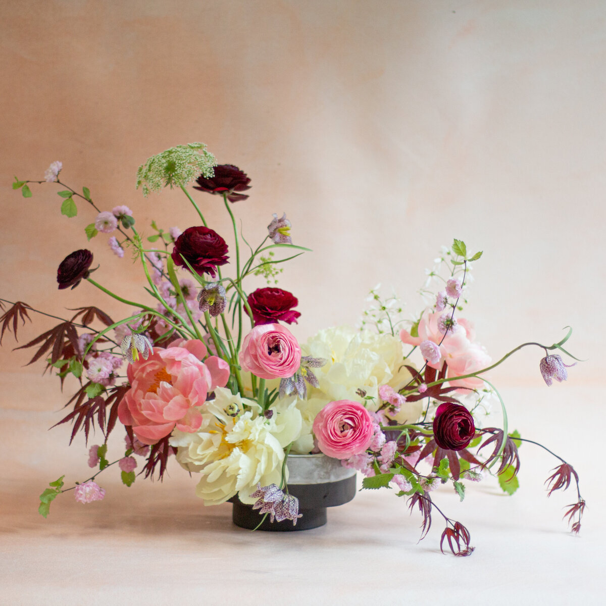 An airy arrangement of spring flowers and lush greenery at a Montreal wedding. 