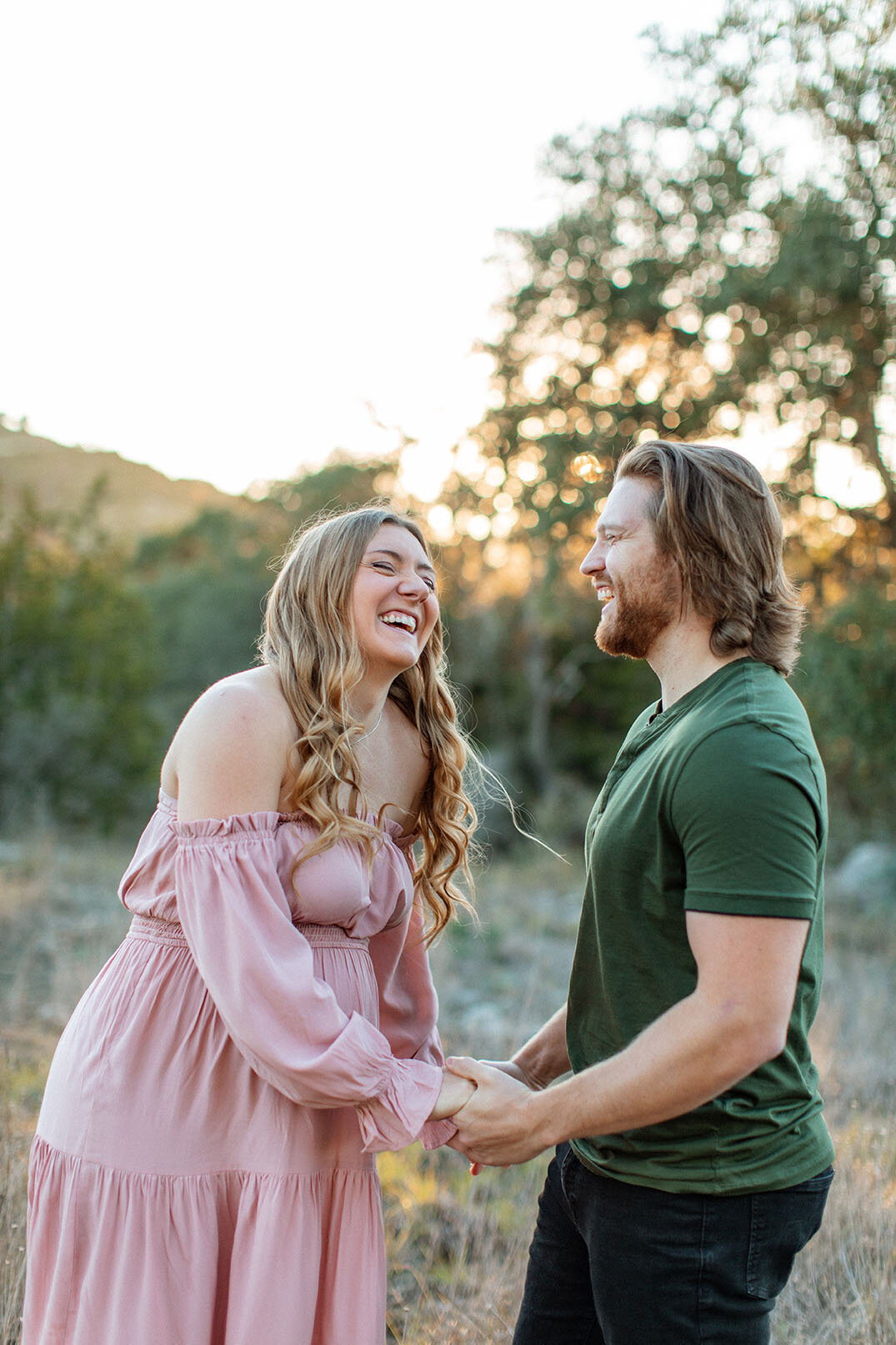 Couple laughing together during portrait session - Sara James San Antonio photographer specializes in capturing genuine connection and joy between partners in Texas engagement and couples photography