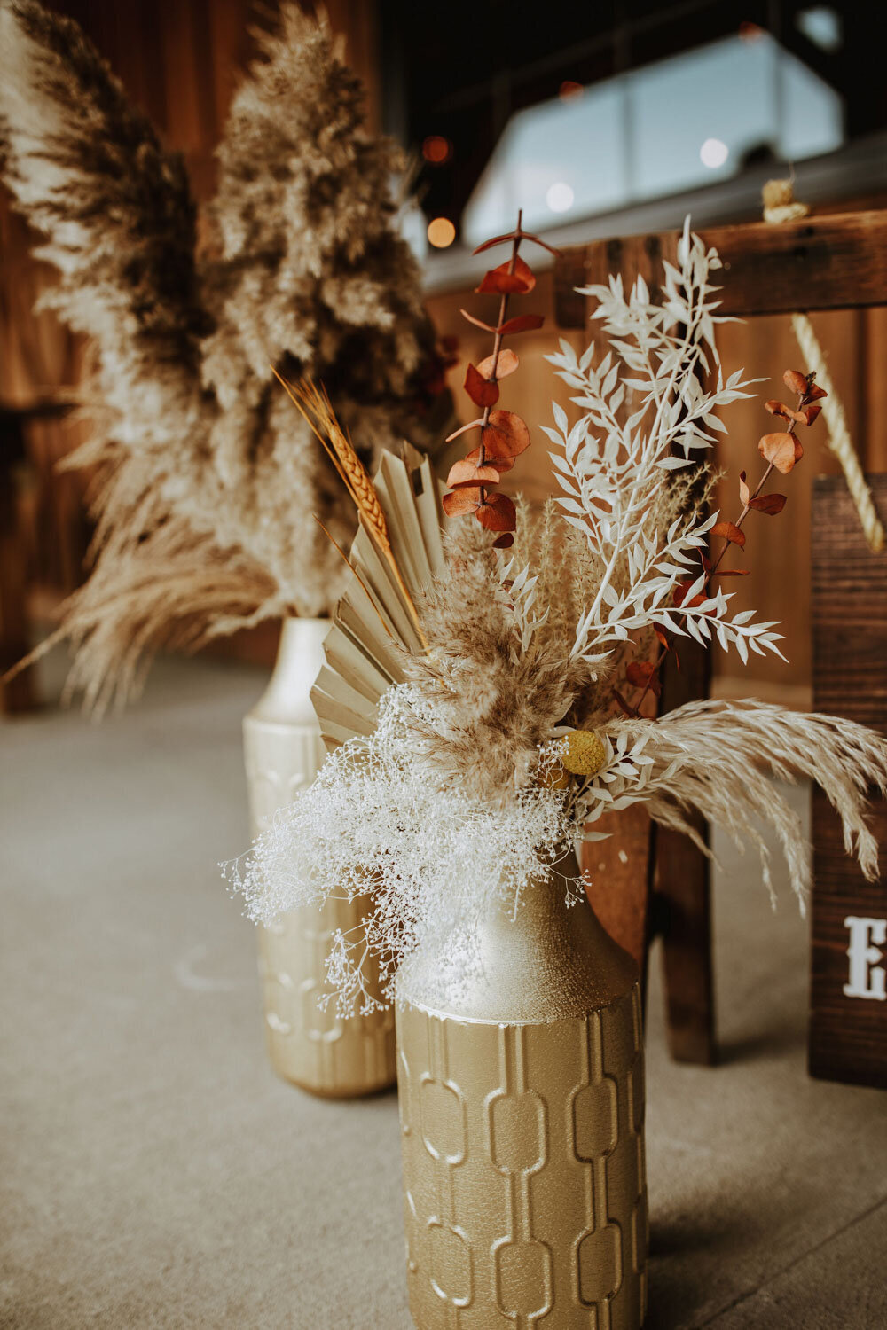 Pampas grass and dried floral arrangement in a gold vase