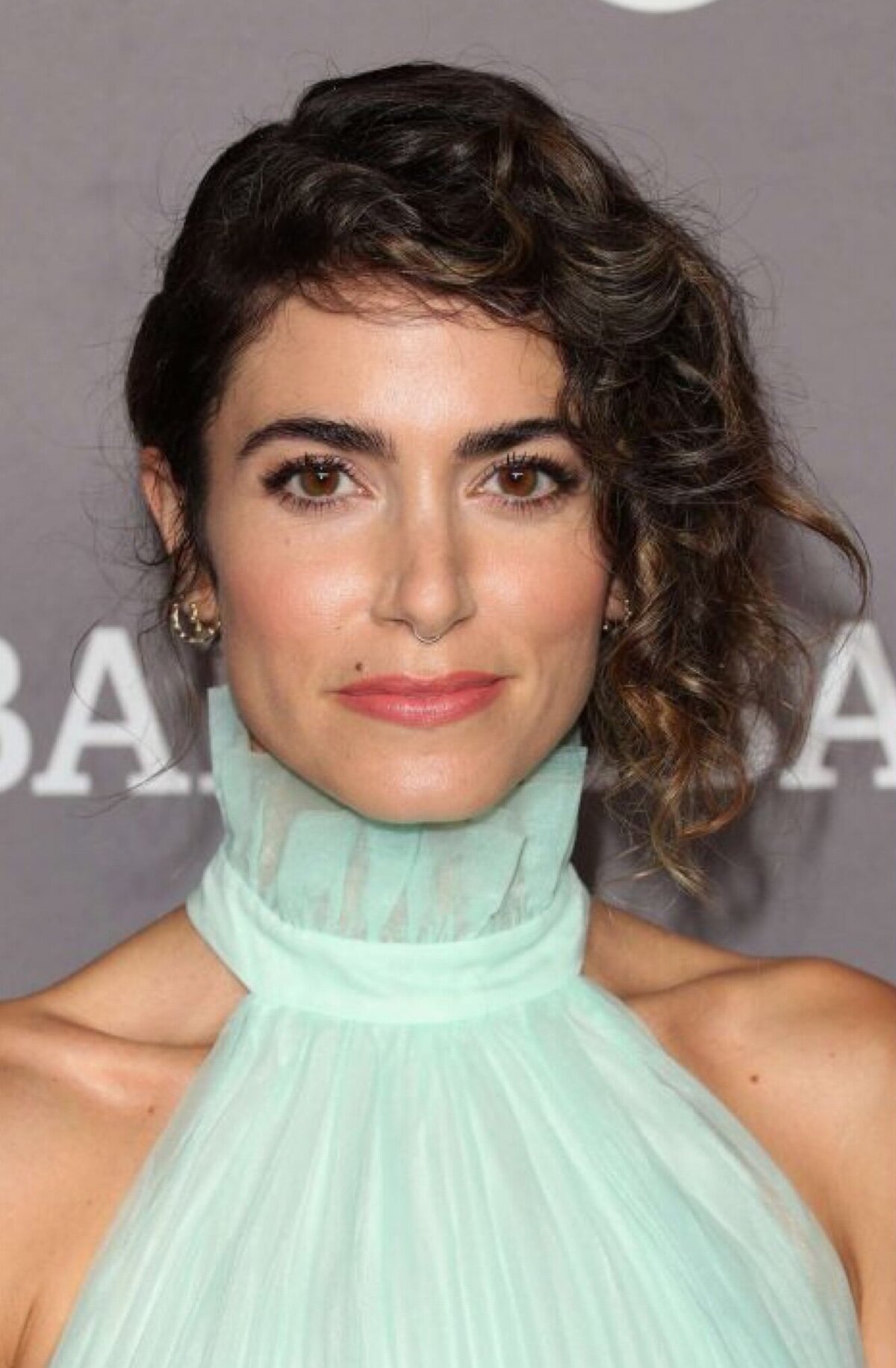 Nikki Reed at the Baby2Baby Gala wearing a mint green dress and neutral makeup