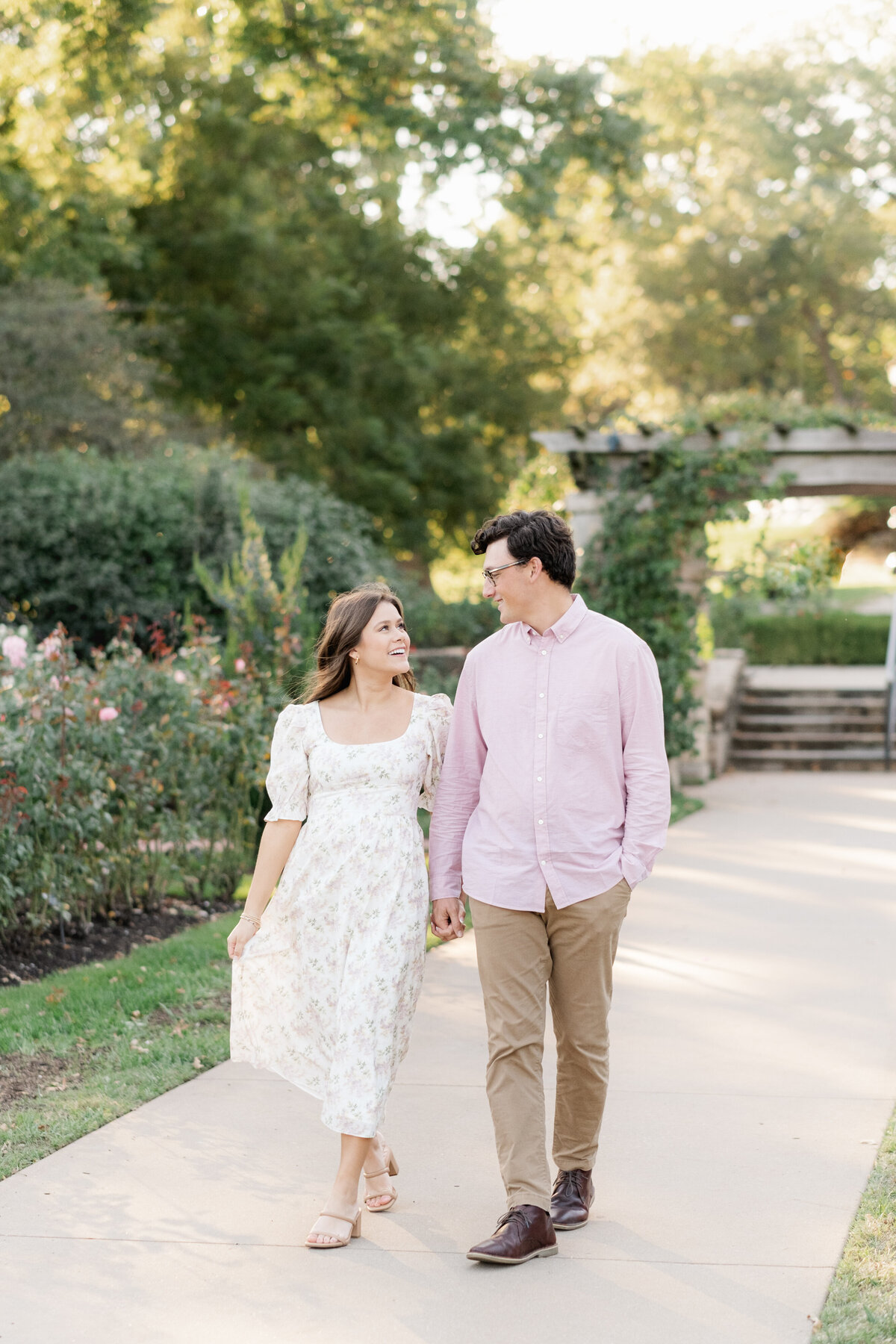 couple walking along path at Loose Park during engagement session
