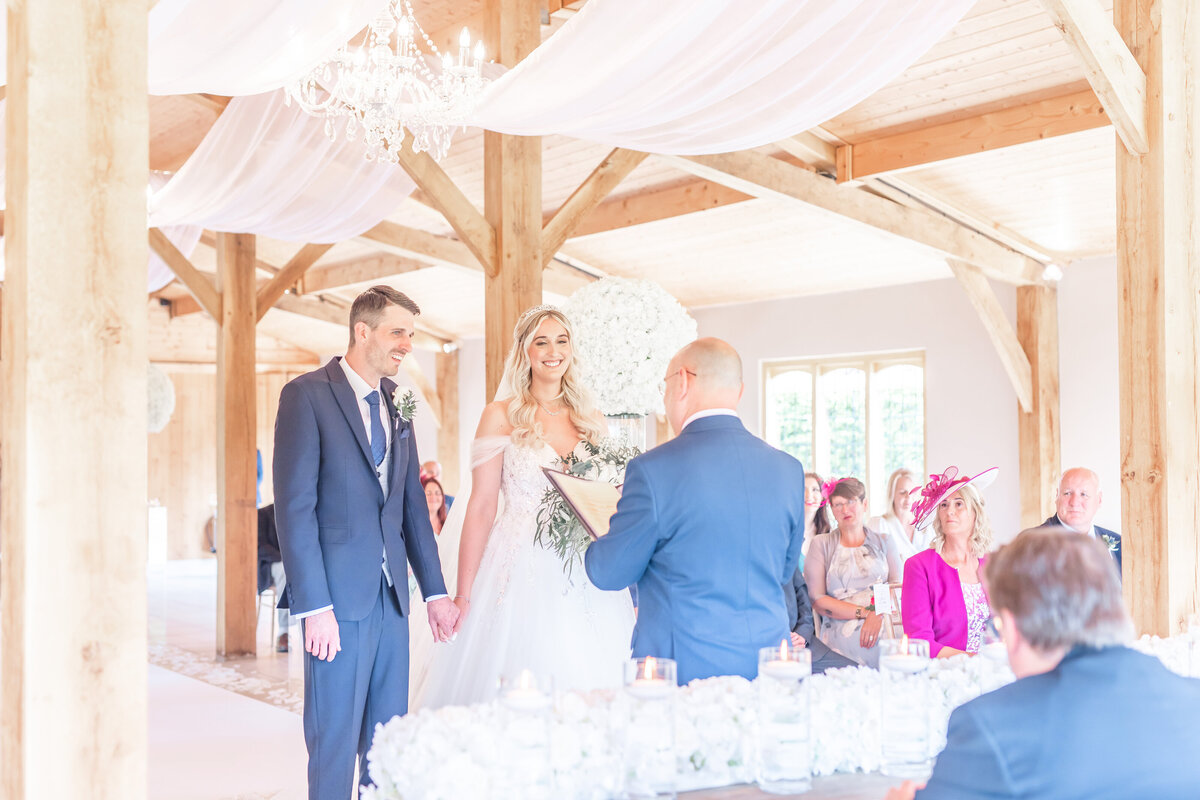 Bride and groom holding hands during their ceremony at Merrydale Manor Cheshire